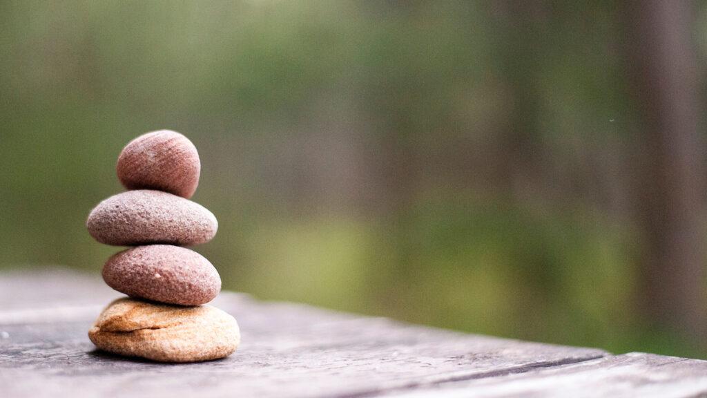Peaceful stacked stones on a wooden surface